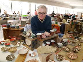 Perry Poupore showcases some of his work during the Empty Bowls fundraiser at Loyalist College Saturday. He donated 12 bowls to the cause.