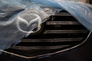 The grill of a Mazda CX-5 covered in protective plastic is seen in the Mazda booth during setup for the 2015 Edmonton Motorshow at Edmonton Expo Centre in Edmonton, Alta., on Sunday, April 5, 2015. The show runs on April 9 -12, and the Precious Metal Gala is set for April 8 at 6:30 p.m. Ian Kucerak/Edmonton Sun/ QMI Agency