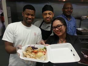 Salvation Army volunteers Ricardo Jeanbace (left), Diana Javier (right), Jeanot Colas (middle) and Chaplain Louis (back right) helped served more than 600 people for an Easter Sunday meal at the Booth Centre on George Street in Ottawa on April 5, 2015. (Keaton Robbins/Ottawa Sun)