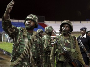 A policeman controls issued orders to his juniors when people rescued from the Garissa University attack meet their relatives at Nyayo stadium in Kenya's capital Nairobi April 4, 2015. (REUTERS/Thomas Mukoya)