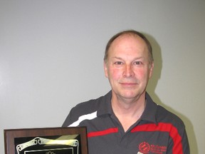 Bob Hughes holds a plaque that recognizes his 30 years of service to the Kinsmen Club in Chatham.
(Blair Andrews/Chatham This Week