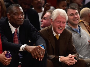 NBA legend Dikembe Mutombo (left) and former president Bill Clinton sit courtside during the 2015 NBA All-Star Game at Madison Square Garden. (Bob Donnan/USA TODAY Sports)