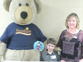 Ten-year-old Griffin, of Clinton, will be going to Walt Disney World in Florida with his family this year as part of the Sunshine Foundation’s dreams program. Griffin is shown here with the Sunshine Bear and Sunshine chapter member JoAnne Knetchel at a Suitcase Party fundraiser in Mitchell. (Contributed photo)