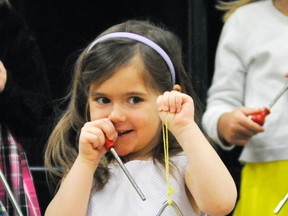 Adrianna Taylor flashes a shy smile before she and her Upper Thames Elementary School (UTES) kindergarten classmates begin their rhythm band performance last Wednesday, April 1, part of the 69th annual Mitchell Optimist Music Festival. ANDY BADER/MITCHELL ADVOCATE