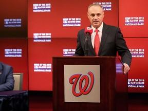 MLB commissioner Robert D. Manfred Jr. talks to the media as Washington Nationals principal owner Mark D. Lerner looks on during a news conference announcing the team will host the 2018 All-Star Game April 6, 2015 in Washington, DC. (Rob Carr/Getty Images/AFP)