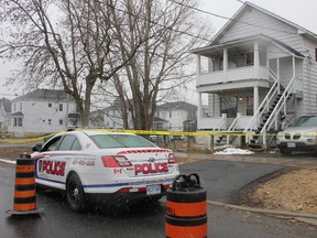 There was a strong police presence on Walton and Carelton Streets on Monday April 6, 2015 in Cornwall, Ont. The body of a 52-year-old woman was found inside a Carelton Street home, and a 28-year-old unidentified male has been charged with murder. Lois Ann Baker/Cornwall Standard-Freeholder/QMI Agency