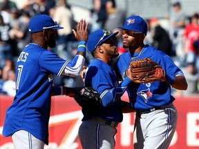 Jose Reyes #7,Devon Travis #29 and Dalton Pompey #45 of the Blue Jays celebrate the win over the New York Yankees in New York on Monday.