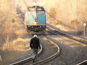 An unidentified man was killed after being struck by a westbound Via Rail train just west of Trenton Junction. The incident occurred shortly before 6:30 p.m. Monday, April 6, 2015. Above, Coroner Dr. Don Cooke walks towards a westbound Via Rail train stopped on the tracks just west of the via station. Quinte West OPP are investigating the incident. A Via Rail spokesperson said rail traffic has been temporarily suspended in both directions. - Ernst Kuglin/The Trentonian/QMI Agency