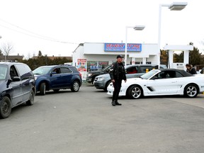 Drivers line up around the block near the Stinson gas station at 1627 Cyrville Road just before noon on Apr. 6, 2015. Store owner George Jeha set his gas price to 79.9 cents per litre between 11:00 a.m. and noon on the day.  
Andrew Meade/Ottawa Sun/QMI Agency