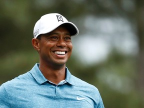 Tiger Woods smiles as he walks up the fourth fairway during his practice round ahead of the Masters at the Augusta National Golf Course in Augusta, Ga., on Monday, April 6, 2015. (Jim Young/Reuters)