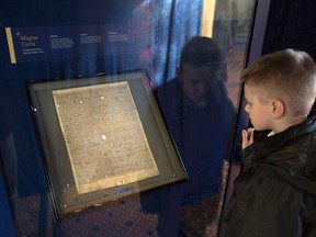 A schoolboy looks at the Salisbury Magna Carta, one of the original four remaining Magna Carta documents at Salisbury Cathedral in southern England. (REUTERS file photo)