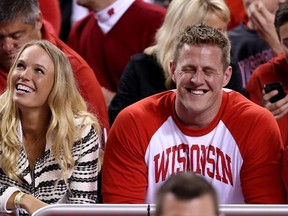 Tennis player Caroline Wozniacki and J.J. Watt of the Houston Texans look on from the crowd during first half action at the NCAA Men's National Championship game between Duke and Wisconsin in Indianapolis on Monday, April 6, 2015. (Streeter Lecka/Getty Images/AFP)