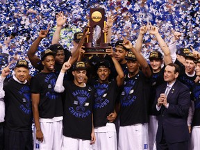 Duke Blue Devils players lift the NCAA championship trophy after beating Wisconsin on April 6. (USA Today Sports)
