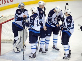 Apr 6, 2015; Saint Paul, MN, USA;  Winnipeg Jets forward Drew Stafford (12) congratulates goalie Ondrej Pavelec (31) on a shut out win over the Minnesota Wild at Xcel Energy Center.  The Jets defeated the Wild 2-0.  Mandatory Credit: Marilyn Indahl-USA TODAY Sports