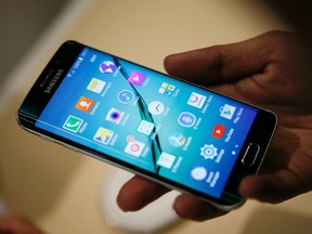 A hostess displays the Galaxy S6 edge smartphone at the Samsung Galaxy Unpacked event before the Mobile World Congress in Barcelona March 1, 2015. REUTERS/Albert Gea