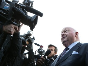 Suspended Senator Mike Duffy walks to the Ottawa court house in Ottawa Tuesday April 7,  2015.  The 68-year-old journalist-turned-senator goes on trial for 31 fraud and bribery charges Tuesday . Tony Caldwell/Ottawa Sun/QMI Agency