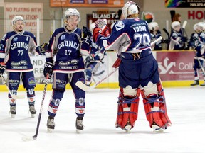 Crunch forwards Josh Racek (17) and Cody Gratton (77) congratulate goaltender Brett Young.