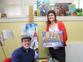 Peter Karas and Corinne Garlick show off some paintings they will be showing off for the tour on April 17 in London, Ont. MIRANDA BRUMWELL\SPECIAL TO THE LONDONER\QMI AGENCY