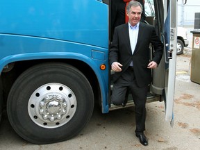 Alberta PC Leader Jim Prentice and his wife, Karen get off of the premiers campaign bus on their way into at Crestwood Hall where Prentice called a provincial election in Edmonton, Alta., on Tuesday April 7, 2015. Perry Mah/Edmonton Sun