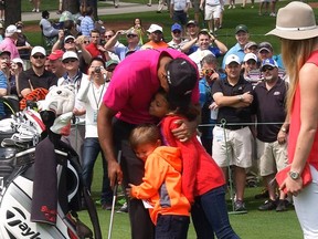 While on the practice area for the 2015 Masters at Augusta National Golf Course, golfer Tiger Woods of the U.S. gets a hug from his daughter Sam and son Charlie as girlfriend Lindsey Vonn looks on in Augusta, Georgia in this still image taken from an April 7, 2015 video.   (REUTERS/Reuters TV-Kevin Fogerty)