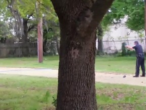 Police Officer Michael Slager in the process of allegedly shooting  Walter Scott. 

(New York Times video)
