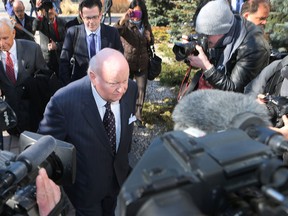 Suspended Senator Mike Duffy leaves the Ottawa court house among a throng of journalists Tuesday April 7,  2015. The 68-year-old journalist-turned-senator attended his first day on trial for 31 fraud and bribery charges Tuesday. Tony Caldwell/Ottawa Sun/QMI Agency