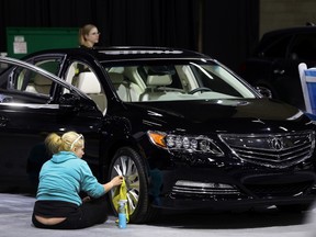 A worker prepares a car for the 2015 Edmonton Motorshow at the Edmonton Expo Centre on Tuesday. The show runs Thursday through Sunday. (Perry Mah/Edmonton Sun)