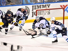 Apr 7, 2015; St. Louis, MO, USA; Winnipeg Jets center Jim Slater (19) blocks the shot of St. Louis Blues right wing T.J. Oshie (74) during the third period at Scottrade Center. The Winnipeg Jets defeat the St. Louis Blues 1-0. Mandatory Credit: Jasen Vinlove-USA TODAY Sports