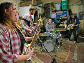 Paterson Hodgson sings vocals for So Young as they practice in her fathers workshop in London, Ont. on Tuesday January 13, 2015. Next to Hodgson is Adam Gilkes on bass, Dave Lunman on drums and Chris Martin on guitar. (Mike Hensen, The London Free Press)