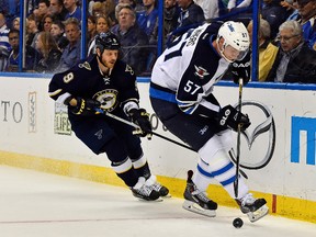 Winnipeg Jets defenseman Tyler Myers (57) controls the puck in front of St. Louis Blues center Steve Ott (9) during the second period at Scottrade Center. (Jasen Vinlove-USA TODAY Sports)