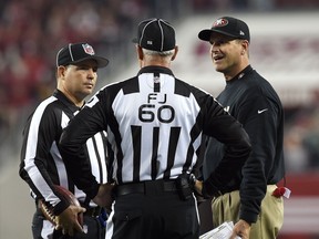Head coach Jim Harbaugh of the San Francisco 49ers talks with on field officials against the Seattle Seahawks at Levi's Stadium on November 27, 2014 in Santa Clara, California. (Thearon W. Henderson/Getty Images/AFP)