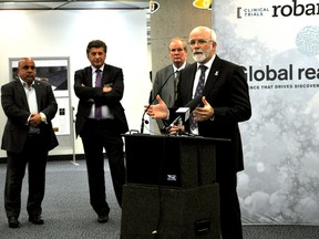 Dr. Michael Strong, dean of Western University’s Schulich School of Medicine and Dentistry, speaks during an announcement in London April 8, 2015. London Clinical Trials Inc. announced it is moving its headquarters from Western to downtown London. Standing nearby is Shmuel Farhi (left), property owner at 100 Dundas Street, John Capone, vice president, research, Western University and Brian Feagan, Robarts Clinical Trials CEO and scientific director. CHRIS MONTANINI\LONDONER\QMI AGENCY