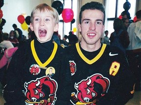 Former Bulls forward Mike Renzi with a young fan at the 1999-2000 Breakfast With The Bulls Lung Association fundraiser at Sir James Whitney School. (Submitted photo)