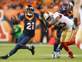 Denver Broncos cornerback Aqib Talib (21) intercepts a pass intended for San Francisco 49ers wide receiver Steve Johnson (13) in the third quarter at Sports Authority Field at Mile High. (Chris Humphreys-USA TODAY Sports)