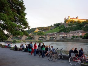 Bring a picnic to the riverbank in Würzburg, Germany, to enjoy a fortress view and convivial people. (photo: Rick Steves)