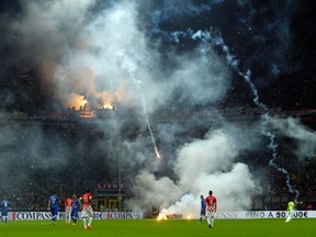 Croatia’s supporter throw flares onto the field during their Euro 2016 qualifying match against Italy at the San Siro stadium in Milan November 16, 2014. (REUTERS/Alessandro Garofalo)