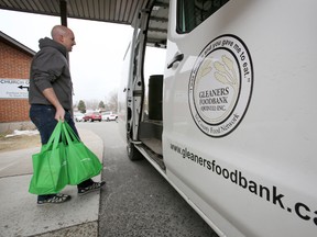 JEROME LESSARD/THE INTELLIGENCER
Mark Hymus of Parkdale Baptist Church on Sidney Street in Belleville carries some of the more than 80 re-usable bags that were filled with mainly non-perishable food items by members of the church over the Easter weekend to the Gleaners Food Bank's truck Wednesday.