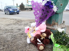 A makeshift memorial is seen for an elderly woman who was killed after being struck by a city bus on Tuesday is seen at Burrows Avenue and Keewatin Street. (Brian Donogh/Winnipeg Sun)