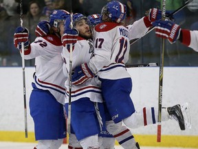 Kingston Voyageurs players celebrate the team's first goal against the Trenton Golden Hawks during Game 6 of the Ontario Junior Hockey League North-East Conference final at the Invista Centre on April 5. The Voyageurs won the game 3-0 to clinch the series. (Ian MacAlpine/The Whig-Standard)