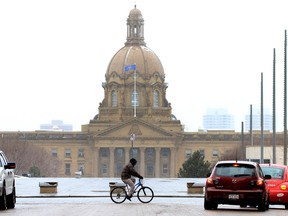 A man passes the Alberta Legislature on his bike last week in Edmonton Alta. Hugo Sanchez/Special to the Edmonton Sun