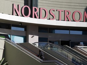A Los Angeles Police Department officer approaches the Nordstrom Rack store in the Westchester area of Los Angeles January 11, 2013, scene of an armed robbery where 14 people were held hostage during an armed robbery.  REUTERS/Jonathan Alcorn
