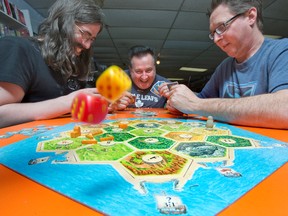 Board game enthusiasts try out The Settlers of Catan. (Postmedia Network file photo)
