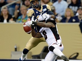 Winnipeg Blue Bombers Aaron Kelly is unable to catch the pass as he is covered by Ottawa Redblacks Jovon Johnson (2) during the second half of their CFL football game in Winnipeg, July 3, 2014. (Reuters Files)