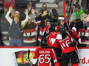 Ottawa Senators players and fans celebrate Mike Hoffman's game-tying goal against the Pittsburgh Penguins during NHL hockey action at the Canadian Tire Centre in Ottawa April 7, 2015. Errol McGihon/Ottawa Sun/QMI Agency