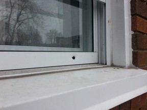 Cops found 10 shell casings ourside 307 York St. Tuesday morning where 8 bullet holes can be seen in the stucco, fence and window frames.
DOUG HEMPSTEAD/Ottawa Sun