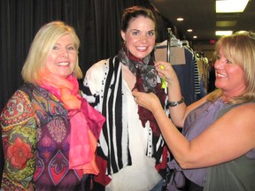 Celebrate Life Fashion Show organizer Marie Anderson, right, adjusts a scarf on model Jennifer Johnstone, as she prepares for the start of the show along with fellow model Cathie Morgan, left. The show took place at Club Lentinas on Wednesday, April 8, 2015. (DON ROBINET, QMI Agency)