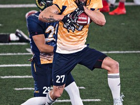 Jordan Reaves of Brandon University makes a catch under pressure from Kahlen Branning of the University of Regina during the CFL Combine at the Commonwealth Field House in Edmonton, Alta., on Monday, March 23, 2015.