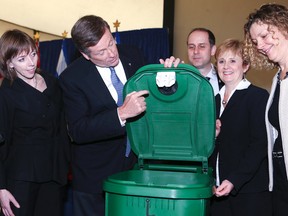 Mayor John Tory demonstrates the features of the "rodent resistant" green bins for organic waste on Thursday, April 9, 2015, at City Hall. (VERONICA HENRI/Toronto Sun)