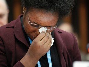 Health worker and Ebola survivor from Sierra Leone Mme Rebecca Johnson cries after addressing the media during a special meeting on Ebola at the WHO headquarters in Geneva, January 25, 2015. REUTERS/Pierre Albouy
