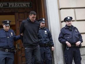 Hawks' Thabo Sefolosha is seen being escorted out of the 10th Precinct of the New York Police Department in Manhattan on April 8, 2015. (Andrew Kelly/Reuters)